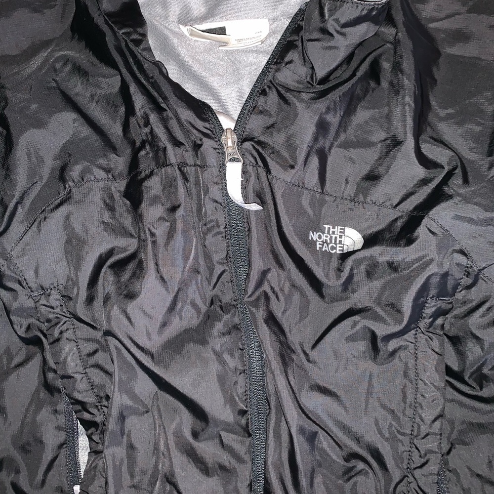 Black North Face rain coat in woman’s S